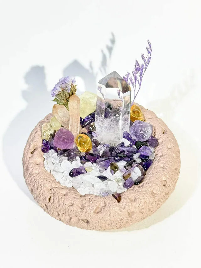 Close view of clear and purple crystals in a textured bowl