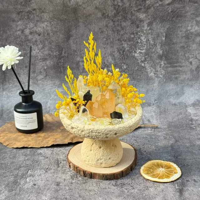 Golden crystal arrangement with yellow botanical details in a pedestal bowl